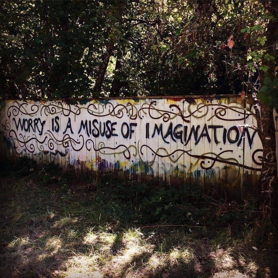 Spray painted on a fence: Worry is a misuse of imagination